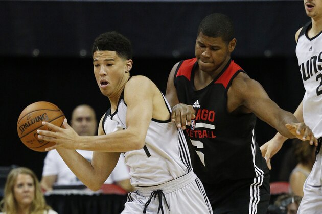 Phoenix Suns’ Devin Booker, left, and Chicago Bulls’ Cristiano Felicio battle for the ball during the first half of an NBA summer league basketball game Saturday, July 18, 2015, in Las Vegas. (AP Photo/John Locher)