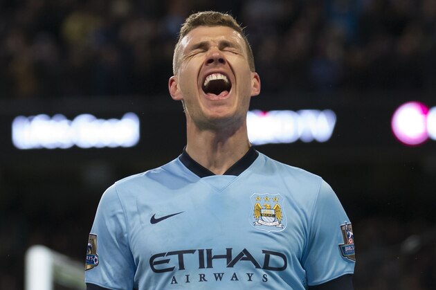 Manchester City's Edin Dzeko celebrates after scoring  during the English Premier League soccer match between Manchester City and Newcastle at the Etihad Stadium, Manchester, England, Saturday Feb. 21, 2015. (AP Photo/Jon Super)