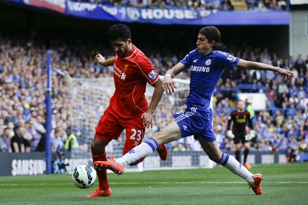 Chelsea's Filipe Luis , right, challenges Liverpool's Emre Can for the ball during their English Premier League soccer match between Chelsea and Liverpool at Stamford Bridge stadium in London, Sunday, May 10,  2015. (AP Photo/Matt Dunham)