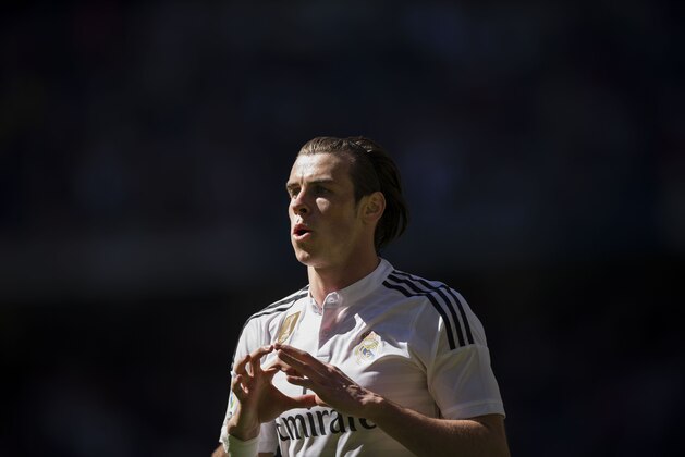 Real Madrid's Gareth Bale celebrates after scoring a goal during a La Liga soccer match between Real Madrid and Granada at the Santiago Bernabeu stadium in Madrid, Spain, Sunday, April 5, 2015. (AP Photo/Daniel Ochoa de Olza)