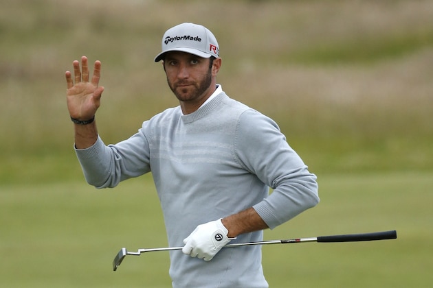 United States’ Dustin Johnson waves after making a putt on the 10th green during the second round of the British Open Golf Championship at the Old Course, St. Andrews, Scotland, Friday, July 17, 2015. (AP Photo/Jon Super)