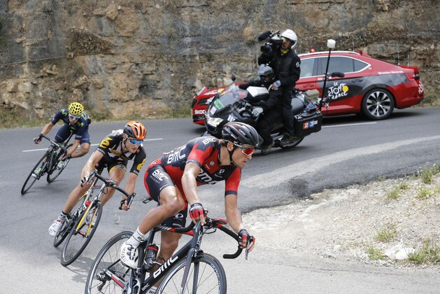 Belgium's Greg van Avermaet, front, Stage winner Britain's Stephen Cummings, center, and Spain's Jonathan Castroviejo, rear, speed down a hairpin turn during the fourteenth stage of the Tour de France cycling race over 178.5 kilometers (110.9 miles) with start in Rodez and finish in Mende, France, Saturday, July 18, 2015. (AP Photo/Laurent Cipriani)