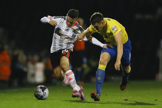 Fulham's Patrick Roberts, left, vies for the ball with Derby's Craig Forsyth during the English League Cup soccer match between Fulham and Derby County at Craven Cottage stadium in London, Tuesday, Oct. 28, 2014. (AP Photo/Kirsty Wigglesworth)