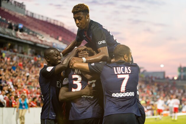 Youssouf Sabaly (31), Christopher Nkunku (33), Lucas Moura (7), and Presnel Kimpembe (34) celebrate a goal during a game between SL Benfica and Paris Saint-Germain, on Saturday, July, 18, 2015 in Toronto, ON. (Mike Janes/AP Images for International Champions Cup)