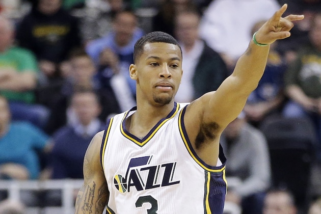Utah Jazz guard Trey Burke points down court in the second half during an NBA basketball game against the Minnesota Timberwolves, Tuesday, Dec. 30, 2014, in Salt Lake City. The Jazz won 100-94. (AP Photo/Rick Bowmer)