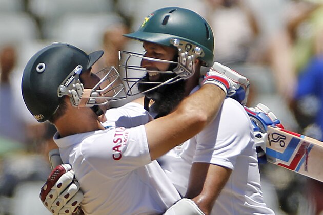 South African Dean Elgar, left, reacts with Hashim Amla, right, as they win against the West Indies during the third test game in Cape Town, South Africa, Tuesday, Jan.  6, 2015.  (AP Photo/Schalk van Zuydam)