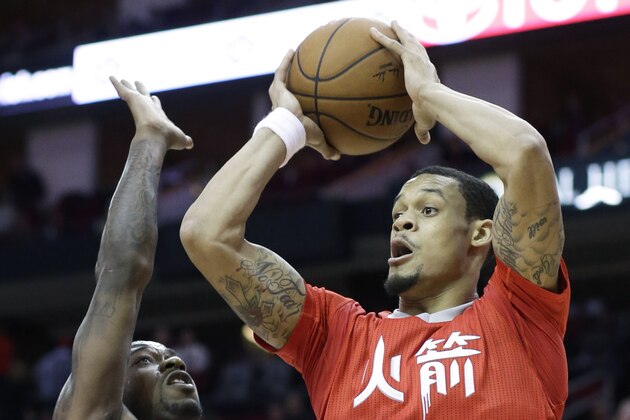 Houston Rockets' KJ McDaniels (32) shoots over Toronto Raptors' Terrence Ross (31) in the second half of an NBA basketball game Saturday, Feb. 21, 2015, in Houston. The Rockets won 98-76. (AP Photo/Pat Sullivan)