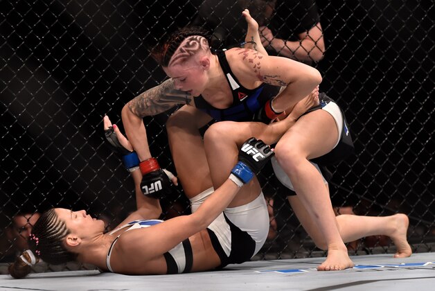 Jul 18, 2015; Glasgow, Lanarkshire, Scotland; Joanne Calderwood (red gloves) grapples with Courtney Casey (blue gloves) on the canvas at The SSE Hydro. Mandatory Credit: Steve Flynn-USA TODAY Sports