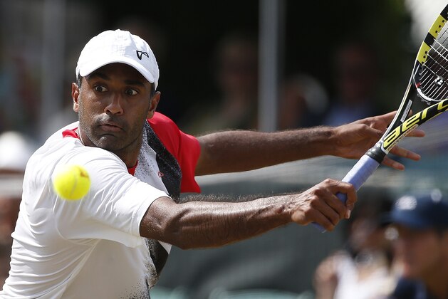 Rajeev Ram plays against John-Patrick Smith, of Australia, during a Tennis Hall of Fame Championship semifinal match in Newport, R.I., Saturday, July 18, 2015. (AP Photo/Michael Dwyer)