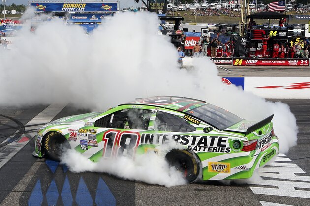 Kyle Busch burns out after winning the NASCAR Sprint Cup series auto race at New Hampshire Motor Speedway Sunday, July 19, 2015, in Loudon, N.H. (AP Photo/Jim Cole)