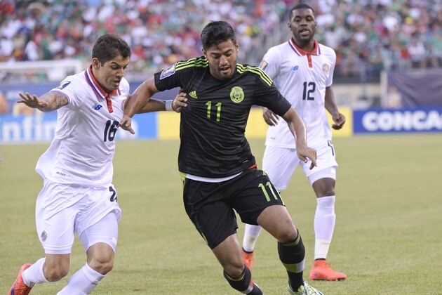 Costa Rica's Christian Gamboa (16) defends Mexico's Carlos Vela (11) during the first half of a CONCACAF Gold Cup soccer match Sunday, July 19, 2015, at MetLife stadium in East Rutherford, N.J. (AP Photo/Bill Kostroun)