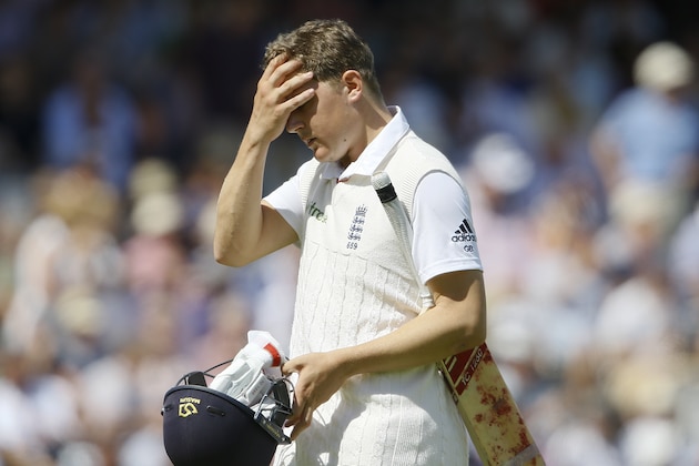 England's Gary Balance leaves the pitch after being caught by Peter Nevill off the bowling of Australia's Mitchell Marsh, left, on the fourth day of the second Ashes Test match between England and Australia, at Lord's cricket ground in London, Sunday, July 19, 2015. (AP Photo/Kirsty Wigglesworth)