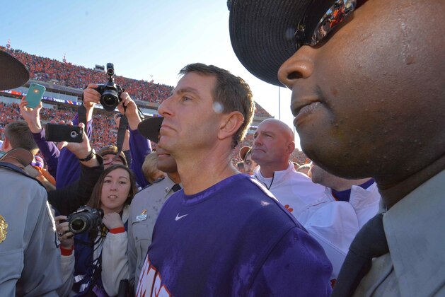 Clemson head coach Dabo Swinney stands with his team and their fans after an NCAA college football game against South Carolina in Clemson, S.C.,  Saturday, Nov. 29, 2014. Clemson won 35-17. (AP Photo/Richard Shiro)