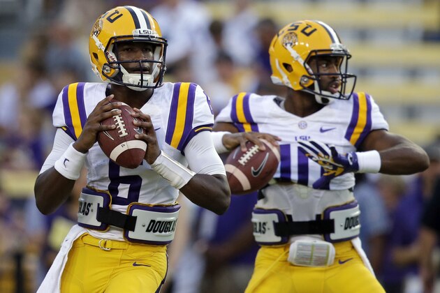 LSU quarterback Brandon Harris (6) and quarterback Anthony Jennings (10) warm hip before an NCAA college football game in Baton Rouge, La., Saturday, Oct. 18, 2014. (AP Photo/Gerald Herbert)