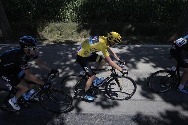 Britain's Chris Froome, wearing the overall leader's yellow jersey, rides with his teammates Britain's Ian Stannard, right, and Britain's Geraint Thomas, left, during the sixteenth stage of the Tour de France cycling race over 201 kilometers (124.9 miles) with start in Bourg-de-Peage and finish in Gap, France, Monday, July 20, 2015. (AP Photo/Laurent Cipriani)
