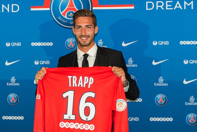 PSG's new coach Kevin Trapp, of Germany, poses with his jersey for media during an official presentation in Paris, France, Monday, July 13, 2015. Paris Saint Germain signed former Eintracht Frankfurt goalkeeper Kevin Trapp on a five-year deal. (AP Photo/Kamil Zihnioglu)