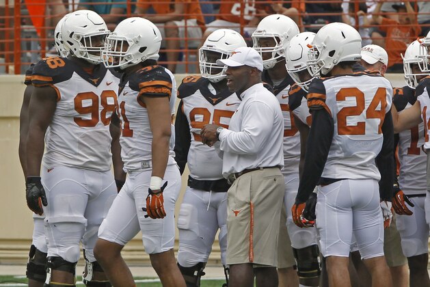 Texas head coach Charlie Strong stands with his team during the first quarter of Texas' Orange and White spring NCAA college football game, Saturday, April 18, 2015, in Austin, Texas. (AP Photo/Michael Thomas)
