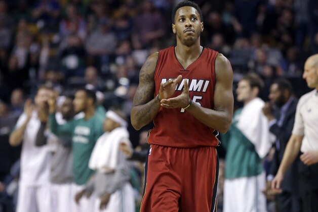 Miami Heat guard Mario Chalmers (15) claps as during a timeout in the second half of an NBA basketball game against the Boston Celtics in Boston, Wednesday, March 25, 2015. The Heat won 93-86. (AP Photo/Elise Amendola)