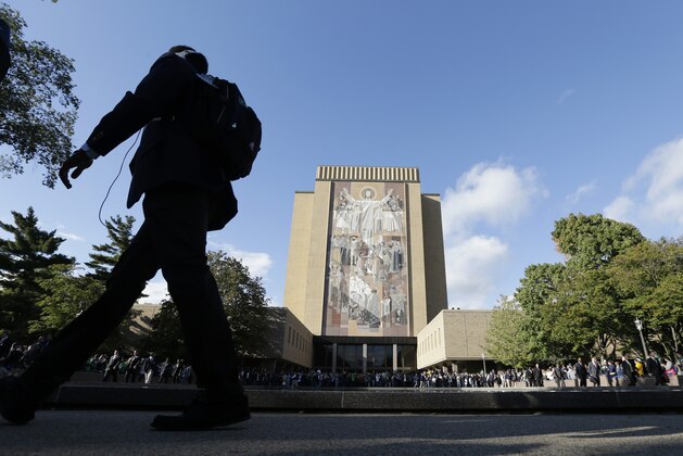 FILE - In this Sept. 22, 2012 file photo fans gather at the the Hesburgh Library with the Word of Life mural, also known as Touchdown Jesus, at the University of Notre Dame before the start of a college football game in South Bend, Ind. The university said Friday, April 2, 2014, that alumnus John W. FILE - In this Sept. 22, 2012 file photo fans gather at the the Hesburgh Library with the Word of Life mural, also known as Touchdown Jesus, at the University of Notre Dame before the start of a college football game in South Bend, Ind. The university said Friday, April 2, 2014, that alumnus John W.
