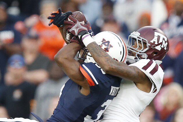 Auburn defensive back Jermaine Whitehead (35) intercepts a pass against Texas A&M wide receiver Edward Pope (18) during the first half of an NCAA college football game Saturday, Nov. 8, 2014, in Auburn, Ala. (AP Photo/Brynn Anderson)