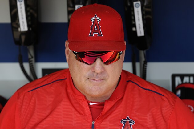 Los Angeles Angels manager Mike Scioscia sits in the dugout before a baseball game against the Seattle Mariners, Sunday, July 12, 2015, in Seattle. (AP Photo/Ted S. Warren)