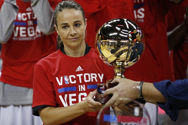 San Antonio Spurs coach Becky Hammon holds up the championship trophy after they defeated the Phoenix Suns in an NBA summer league championship basketball game Monday, July 20, 2015, in Las Vegas. (AP Photo/John Locher)