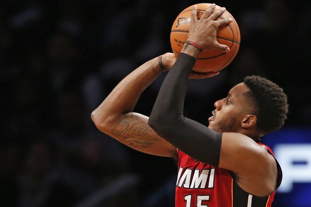 Miami Heat guard Mario Chalmers (15), who scored 22 points, shoots a three point shot in the second half of an NBA basketball game against the Brooklyn Nets Monday, Nov. 17, 2014. The Heat defeated the Nets 95-83. (AP Photo/Kathy Willens)