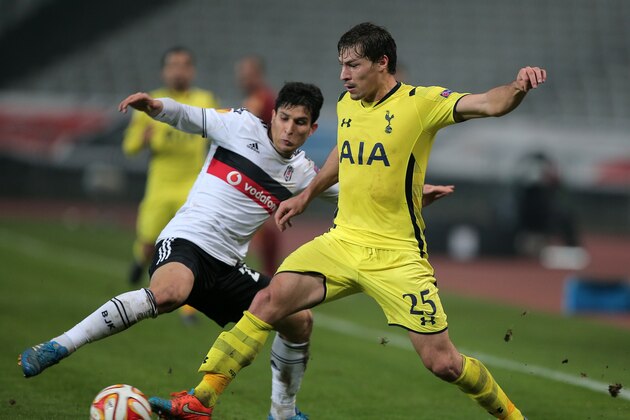 Besiktas's Necip Uysal, left, and Benjamin Stambouli of Tottenham fight for the ball during their Europa League Group C  stage soccer match at Ataturk Olimpiyat Stadium in Istanbul, Turkey, Thursday, Dec. 11, 2014.(AP Photo)