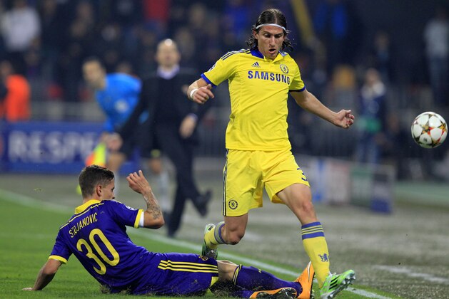 Chelsea's Filipe Luis, right, fights for a ball with Maribor's Petar Stojanovic during the Champions League group G soccer match between Chelsea FC and Maribor, in Maribor, Slovenia, Wednesday, Nov. 5, 2014. (AP Photo/Nikola Solic)