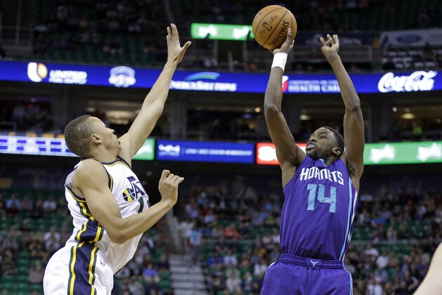 Charlotte Hornets forward Michael Kidd-Gilchrist (14) shoots as Utah Jazz guard Dante Exum, left, defends in the first quarter in an NBA basketball game Monday, March 16, 2015, in Salt Lake City. (AP Photo/Rick Bowmer)