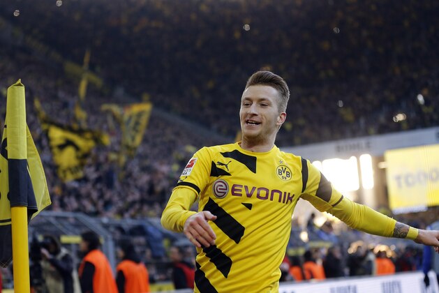 Dortmund's Marco Reus celebrates after scoring  during the German first division Bundesliga soccer match between BvB Borussia Dortmund  and Schalke 04 in Dortmund, Germany, Saturday, Feb. 28, 2015. (AP Photo/Frank Augstein)