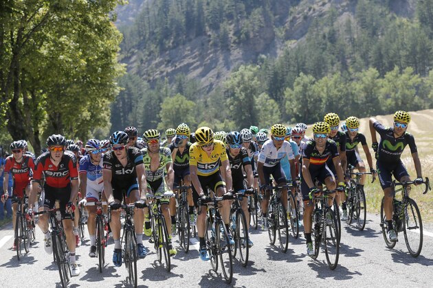 Tejay van Garderen of the U.S., far left, Britain's Chris Froome, wearing the overall leader's yellow jersey, Colombia's Nairo Quintana, wearing the best young rider's white jersey, and Spain's Alejandro Valverde, fourth right, ride in the pack during the sixteenth stage of the Tour de France cycling race over 201 kilometers (124.9 miles) with start in Bourg-de-Peage and finish in Gap, France, Monday, July 20, 2015. (AP Photo/Christophe Ena)