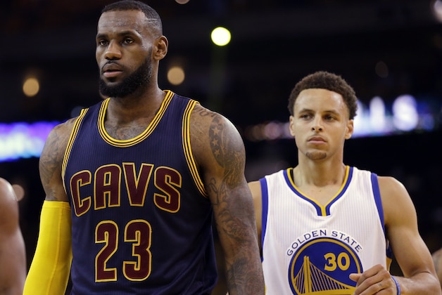 Cleveland Cavaliers forward LeBron James (23) walks in front of Golden State Warriors guard Stephen Curry (30) during the first half of Game 5 of basketball's NBA Finals in Oakland, Calif., Sunday, June 14, 2015. (AP Photo/Ben Margot)
