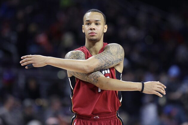 Miami Heat guard Shabazz Napier stretches during the second half of an NBA basketball game against the Detroit Pistons, Tuesday, Feb. 3, 2015 in Auburn Hills, Mich. The Pistons defeated the Heat 108-91. (AP Photo/Carlos Osorio)