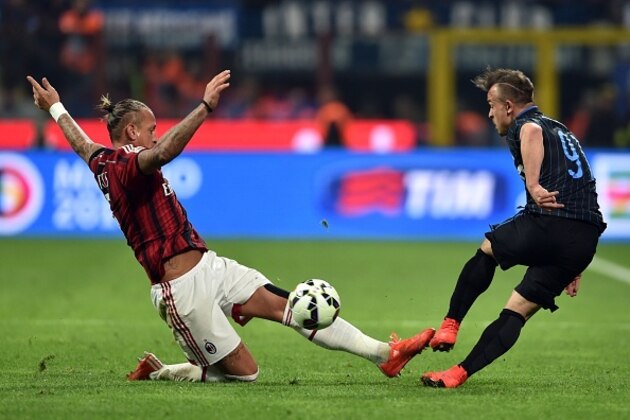AC Milan's defender from France Philippe Mexes (L) fights for the ball with Inter Milan's midfielder from Swiss Xherdan Shaqiri  during their Serie A football match between Inter Milan and AC Milan at San Siro Stadium in Milan on April 19, 2015. AFP PHOTO / GIUSEPPE CACACE        (Photo credit should read GIUSEPPE CACACE/AFP/Getty Images)