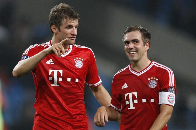 Bayern's Thomas Mueller, left, and Philipp Lahm smile after winning the Champions League group D soccer match between Manchester City and Bayern Munich at the Etihad Stadium in Manchester, England, Wednesday, Oct. 2, 2013. (AP Photo/Jon Super)