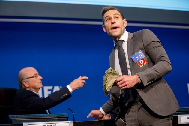 ZURICH, SWITZERLAND - JULY 20: Comedian Simon Brodkin prepares to attack FIFA President Joseph S. Blatter (R) with money during a press conference at the Extraordinary FIFA Executive Committee Meeting at the FIFA headquarters on July 20, 2015 in Zurich, Switzerland. (Photo by Philipp Schmidli/Getty Images)