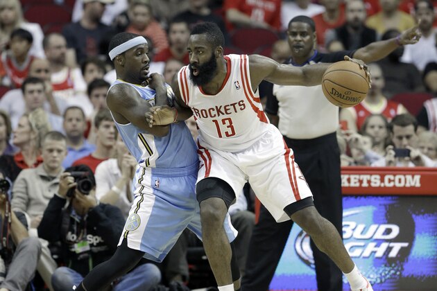 Houston Rockets' James Harden (13) pushes against Denver Nuggets' Ty Lawson in the first half of an NBA basketball game Saturday, Nov. 16, 2013, in Houston. (AP Photo/Pat Sullivan)