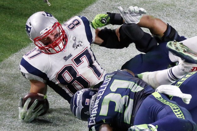 Seattle Seahawks outside linebacker K.J. Wright (50) and Seattle Seahawks strong safety Kam Chancellor (31) hit New England Patriots tight end Rob Gronkowski (87) during the second half of NFL Super Bowl XLIX football game Sunday, Feb. 1, 2015, in Glendale, Ariz. (AP Photo/Ross D. Franklin)