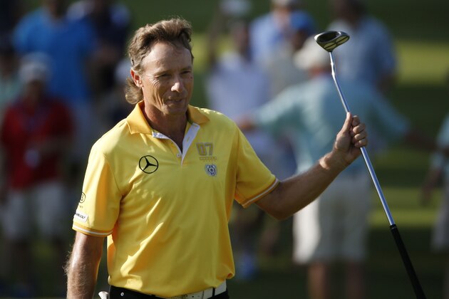Bernhard Langer, of Germany, raises his club as he walks onto the 18th green during the final round of the Senior Players Championship golf tournament in Belmont, Mass., Sunday, June 14, 2015. (AP Photo/Michael Dwyer)
