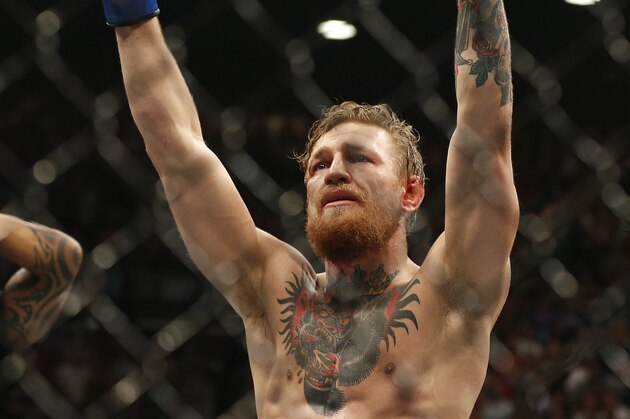 Conor McGregor celebrates after defeating Chad Mendes in their interim featherweight title mixed martial arts bout at UFC 189 Saturday, July 11, 2015, in Las Vegas. (AP Photo/John Locher)