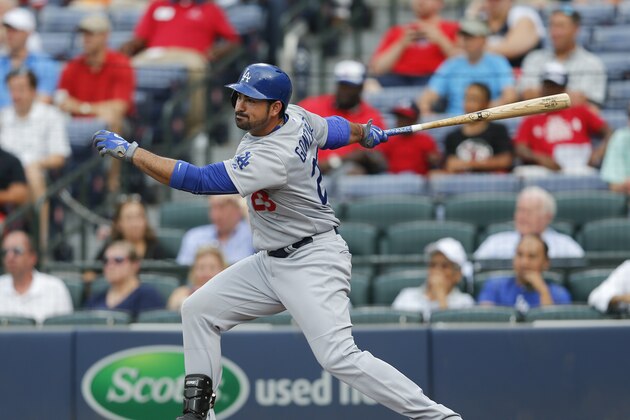 Los Angeles Dodgers first baseman Adrian Gonzalez (23) follows through in the first inning of a baseball game against the Atlanta Braves Monday, July 20, 2015, in Atlanta. (AP Photo/John Bazemore)