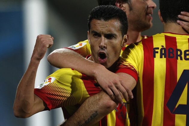 FC Barcelona's Pedro Rodriguez, left, celebrates Cesc Fabregas' goal with teammates during a Spanish La Liga soccer match between FC Barcelona and Getafe at the Coliseum Alfonso Perez stadium in Madrid, Spain, Sunday, Dec. 22, 2013. (AP Photo/Andres Kudacki)