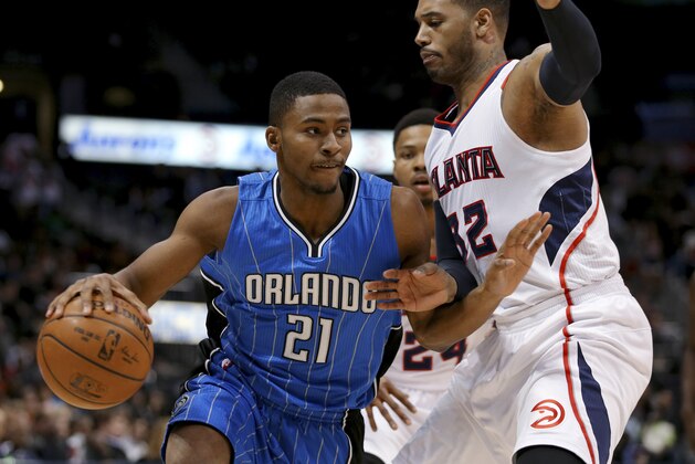 Orlando Magic forward Maurice Harkless (21) drives to the basket against Atlanta Hawks forward Mike Scott (32) during the first half of an NBA basketball game on Friday, Feb. 27, 2015, in Atlanta. (AP Photo/Todd Kirkland)