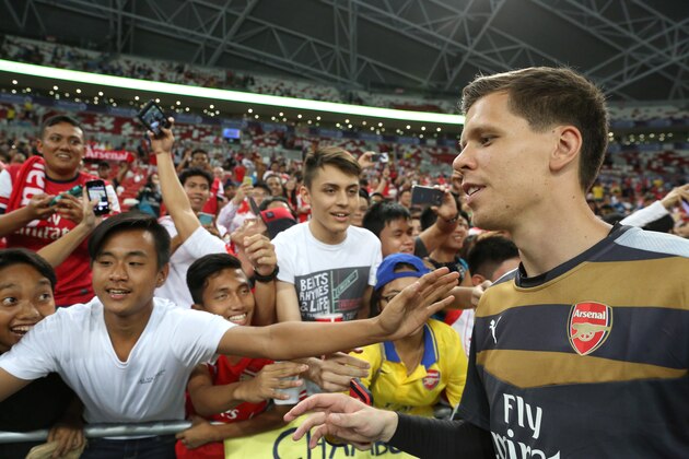 SINGAPORE - JULY 15:  Wojciech Szczesny of Arsenal takes photographs with fans after the Barclays Asia Trophy match between Arsenal and Singapore Select XI at National Stadium on July 15, 2015 in Singapore.  (Photo by Lionel Ng/Getty Images)