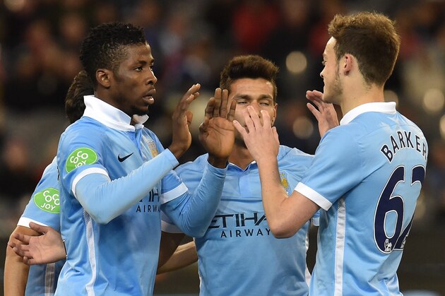 Kelechi Iheanacho (L) of Manchester City is congratulated by teammates after scoring a goal at the International Champions Cup football match between English Premier League team Manchester City and Italian side AS Roma in Melbourne on July 21, 2015. AFP PHOTO / Paul CROCK -- IMAGE RESTRICTED TO EDITORIAL USE - STRICTLY NO COMMERCIAL USE        (Photo credit should read PAUL CROCK/AFP/Getty Images)