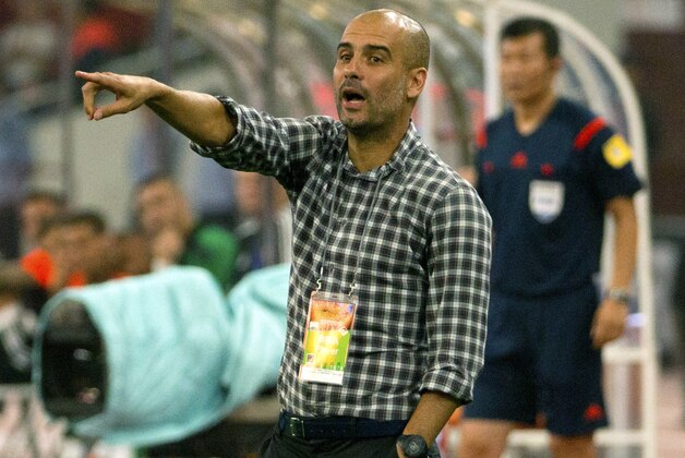 Bayern head coach Pep Guardiola gives instructions to his team during the second half of their friendly soccer match against Valencia in Beijing, Saturday, July 18, 2015. Bayern Munich beat Valencia, 4-1. (AP Photo/Mark Schiefelbein)