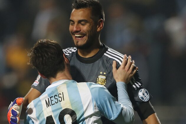 Argentina's Lionel Messi celebrates with teammate goalkeeper Sergio Romero  after the penalty shootout during a Copa America quarterfinal soccer match at the Sausalito Stadium in Vina del Mar, Chile, Friday, June 26, 2015. Argentina defeated Colombia 5-4 on penalties after a 0-0 draw on Friday to reach the semifinals of the Copa America.(AP Photo/Andre Penner)