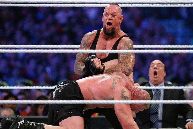 IMAGE DISTRIBUTED FOR WWE - The Undertaker, top, and Brock Lesnar wrestle during Wrestlemania XXX at the Mercedes-Benz Super Dome in New Orleans on Sunday, April 6, 2014. (Jonathan Bachman/AP Images for WWE)