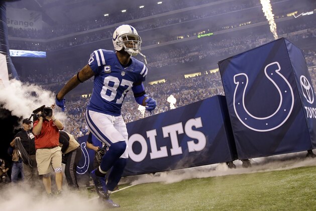 Indianapolis Colts wide receiver Reggie Wayne runs onto the field before the start of an NFL wildcard playoff football game between the Indianapolis Colts and the Cincinnati Bengals Sunday, Jan. 4, 2015, in Indianapolis. (AP Photo/AJ Mast)